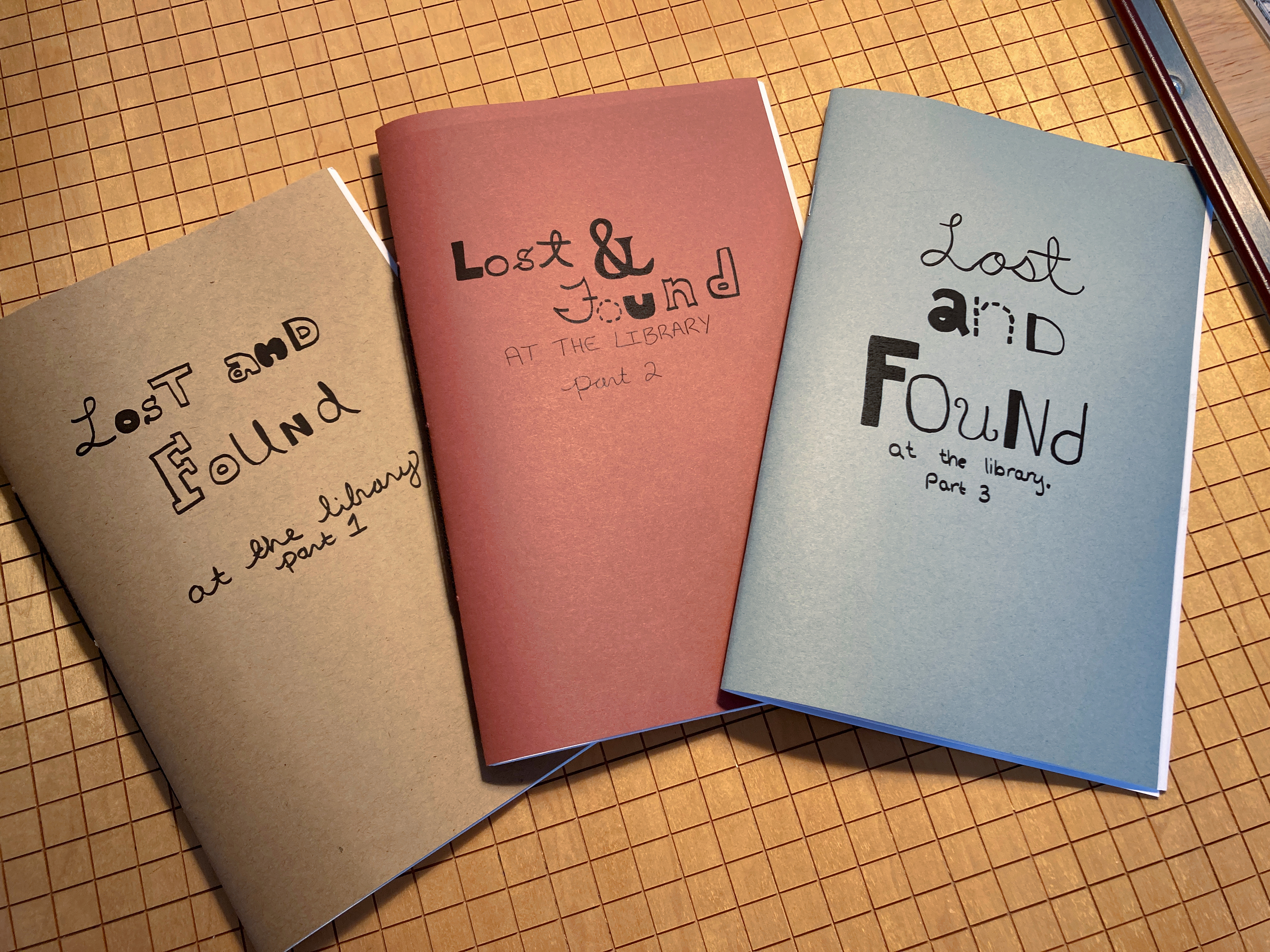 image of three books, red, brown and blue, on a table. titled lost and found at the library